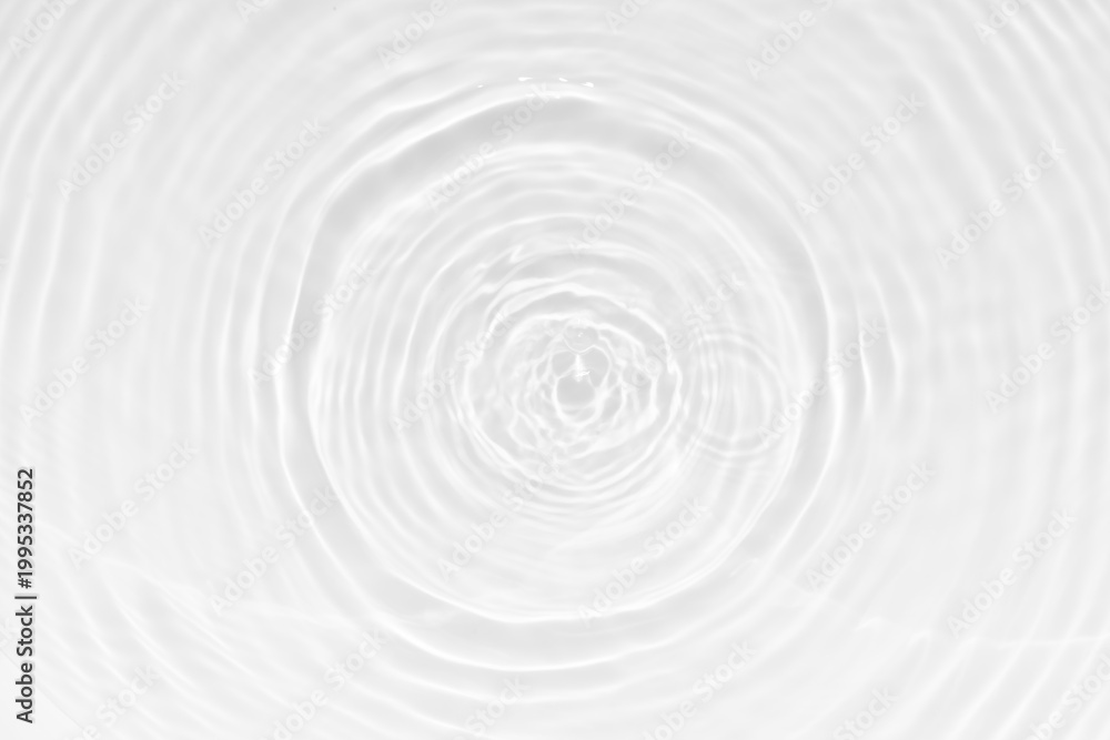 Fototapeta premium White water with ripples on the surface. Defocus blurred transparent white colored clear calm water surface texture with splashes and bubbles. Water waves with shining pattern texture background.