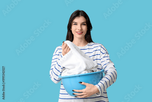 Happy young woman holding b...