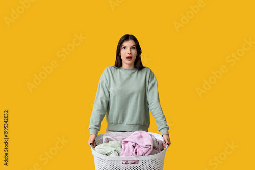 Shocked young woman holding...