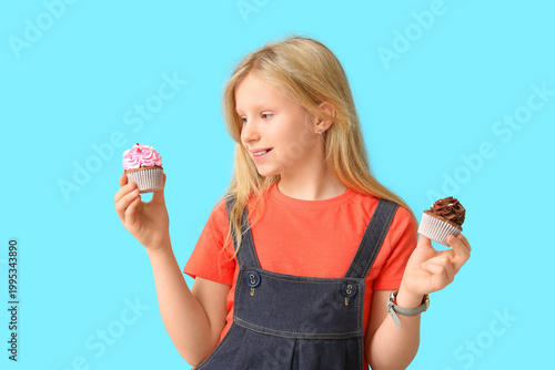 Cute little girl holding cu...