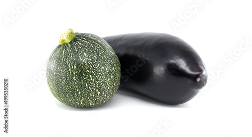 Round green zucchini and dark purple eggplant displayed together on a clean white background