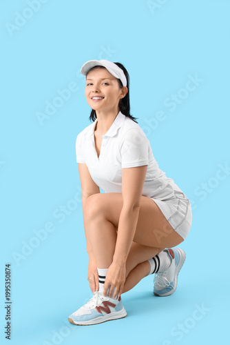 Sporty young woman tying sh...