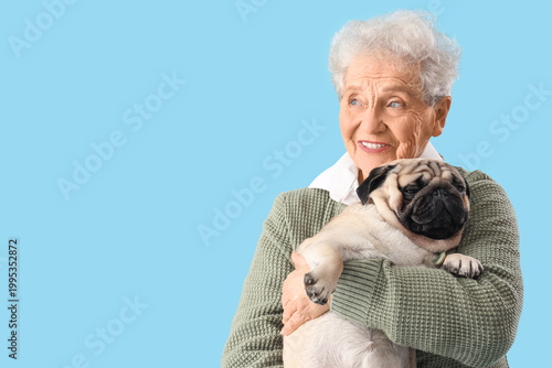 Senior woman with pug dog o...