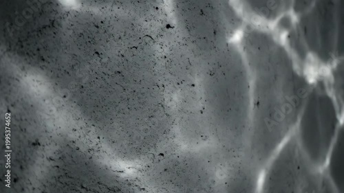 Dramatic abstract concrete texture background with wavy shadows and natural light grunge effect.