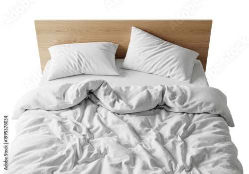 Overhead view of an unmade kingsize bed with messy white cotton duvet, plush pillows, and a light oak headboard in a white studio concept of morning comfort
