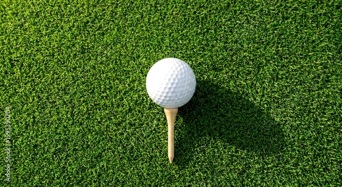 Close-up of a white golf ball on a wooden tee over green grass field background