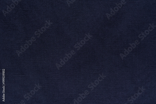 Navy blue fabric texture background, blend of rayon, linen, and cotton fibers. Close-up of woven textile material with natural slub pattern.