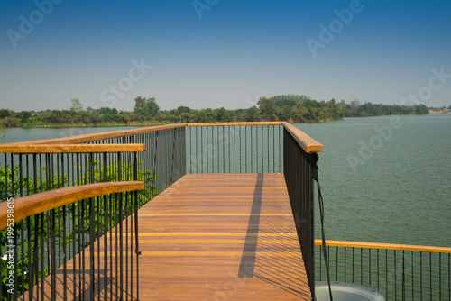 Foto Wooden terrace to reach in the lake for relax in the park with a view of the river and   forest