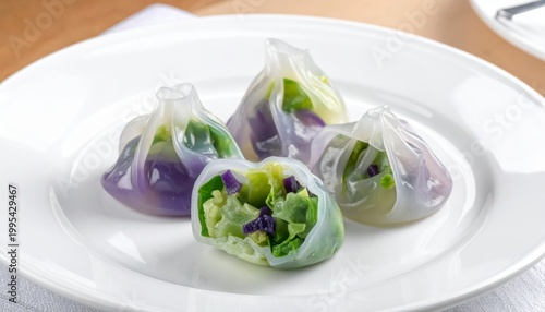 Delicate crystal vegetable dumplings with translucent wrappers showcasing colorful fillings on a white plate