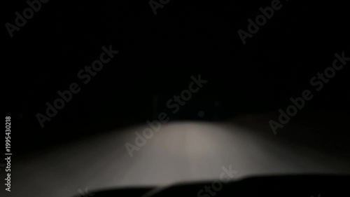Driving at night along rural dirt road with vehicle point of view perspective