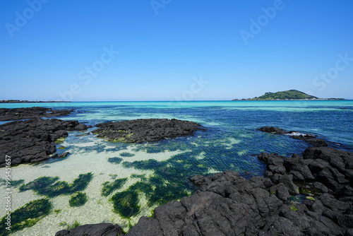 clear shoaling beach and far island