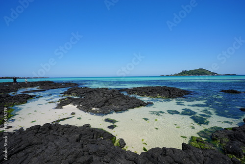 clear shoaling beach and far island