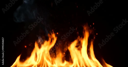 Vibrant dancing flames with rising smoke against a solid black background.