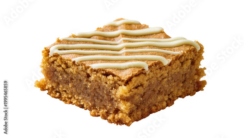 Golden brown baked blondie with white icing drizzle, isolated on transparent background