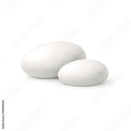 Two white oval stones or pebbles on a surface