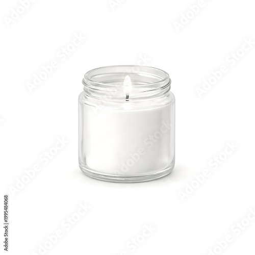 A lit white candle in a glass jar