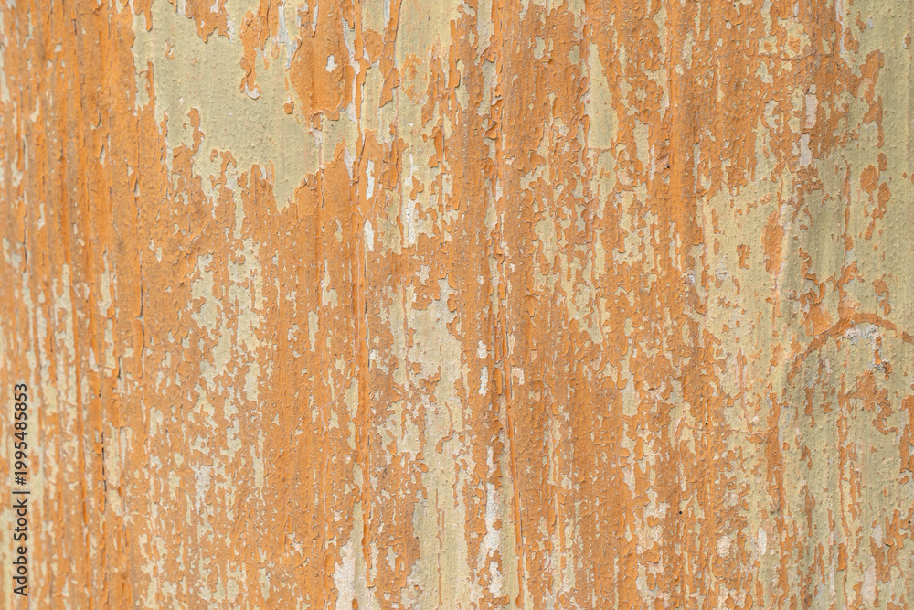 Fototapeta premium Peeling orange wall texture with vertical streaks and weathered paint, ideal for grunge background, abstract design, and urban decay concept.