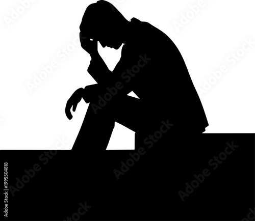 Silhouette of a depressed man sitting with head in hand representing sadness and mental health issues