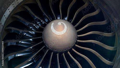 High angle close up of commercial aircraft engine turbine fan blades with spiral spinner mark for aviation engineering and technical maintenance concept