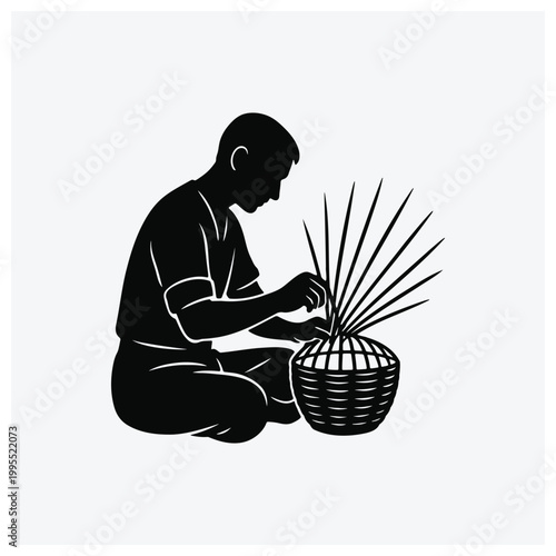 Silhouette of a craftsman weaving or assembling reeds into a basket.