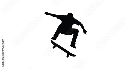 Silhouette of a skateboarder performing a trick in mid air