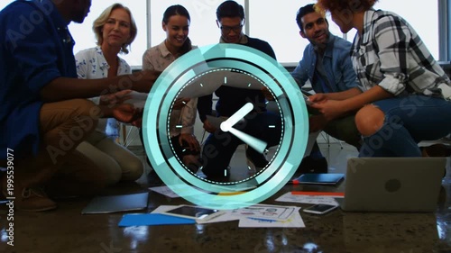 Creative team crouching, teal animated clock pulsing, spurring checking, sorting and tossing papers