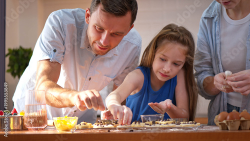 Bilde på lerret Family bonding moment in the kitchen as parents and daughter bake together
