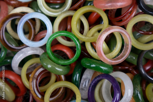 Beautiful rings made of jade are piled high.옥으로 만든 아름다운 반지들이 수북히 쌓여있습니다.