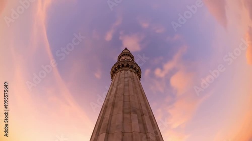 Low Angle Cinematic Minaret Against Swirling Pastel Sunset Sky Timelapse
