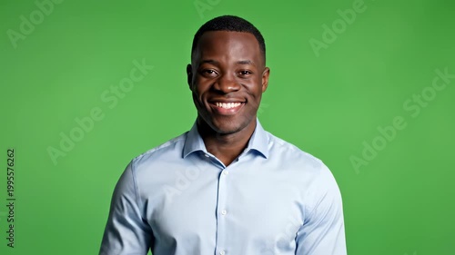 Happy Black Man Smiling and Making a Fist Gesture on Green Screen Background.