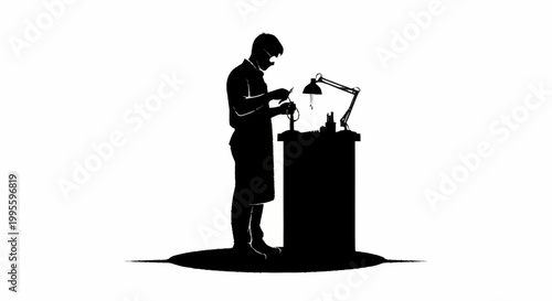 A skilled craftsman works intently at a workbench under a lamp.