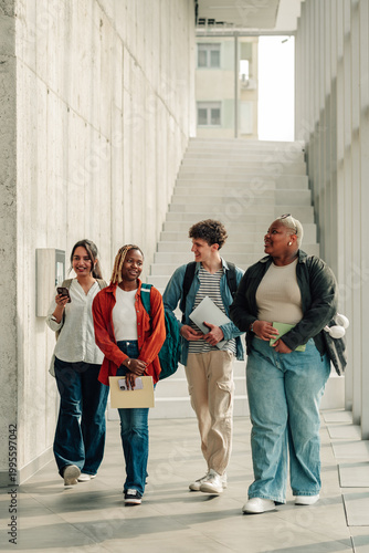 Fotografie Group of diverse university students walking and talking on modern campus hallwa
