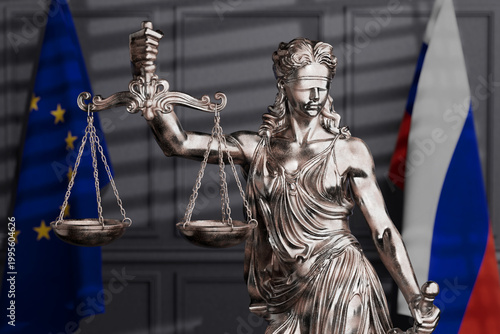 International Justice And Sanctions Dispute. Femida Statue With Scales Between European Union And Russian Flags In Blurred Courtroom Interior. 3D Rendering
