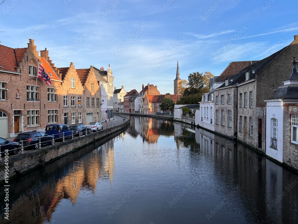 Obraz premium Picturesque view of a canal with medieval brick houses in Bruges, Belgium