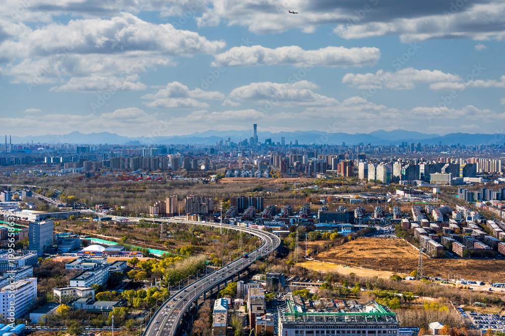 Naklejka premium Beijing urban cityscape with distant mountains in the background