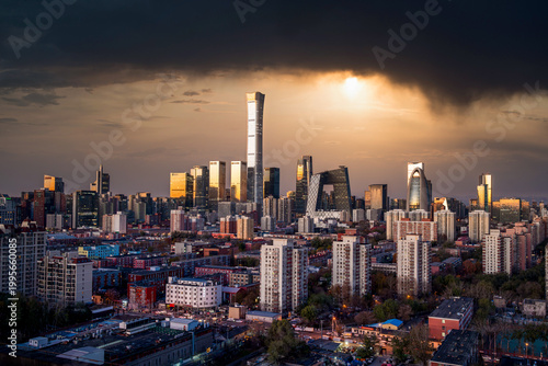 Beijing city skyline and architectural cluster under dramatic storm clouds and crepuscular rays, China