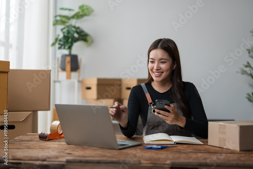 Young woman managing online business preparing customer orders
