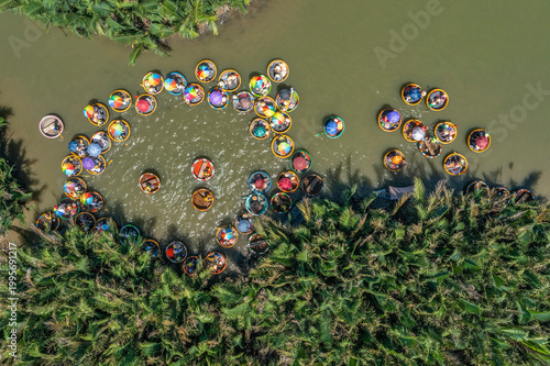Aerial view, tourists from Thailand, Korea, America and Japan are relax and experiencing a basket boat tour at the coconut water ( mangrove palm ) forest in Cam Thanh village, Hoi An, Da Nang, Vietnam