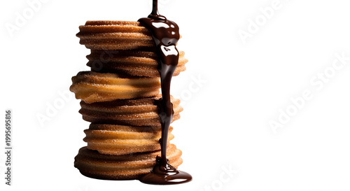 Chocolate sauce drips down a stack of freshly baked donuts on a plate