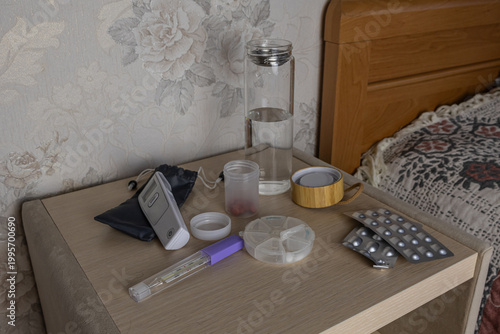 Canvas Print Nightstand with Medicines, Water Bottle and Medical Thermometer