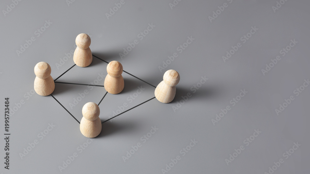Obraz premium Connected team network with wooden figures, communication concept