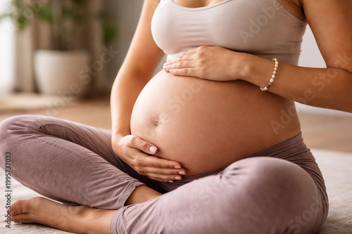 Pregnant woman gently holding her belly close up