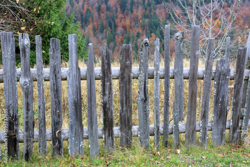 Weathered wooden fence in a rural landscape during autumn
