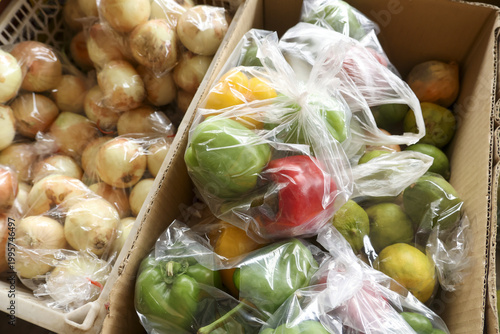 Quadro em tela Box of fresh assorted fruit produce wrapped in plastic bag ready for market sale