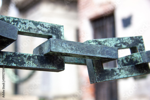 A ground-level view of a colorful street in the Caminito area of La Boca, Buenos Aires. The bright yellow and blue corrugated metal buildings feature traditional 