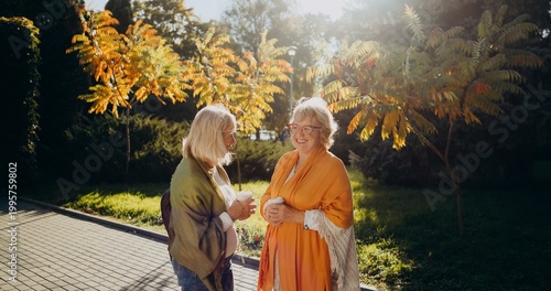 Photos Senior women engaging in happy outdoor conversation