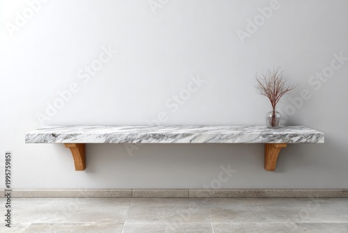 Minimalist marble shelf with wood brackets displays dry plant.