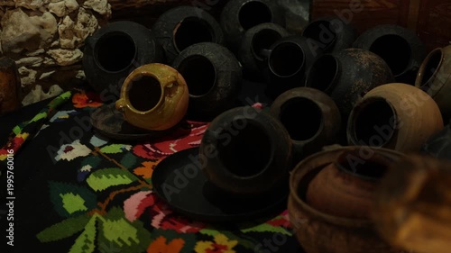 Handmade earthenware and jugs showcased within warm ambiance