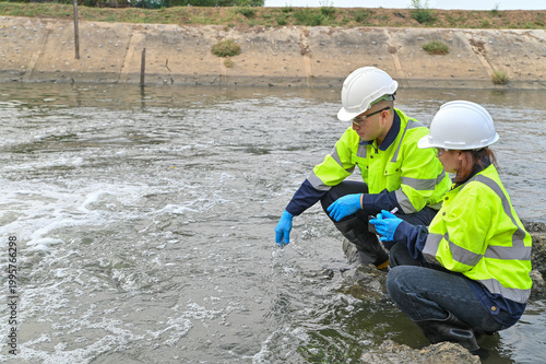 Scientists Performing Environmental Water Testing in Outdoor Setting