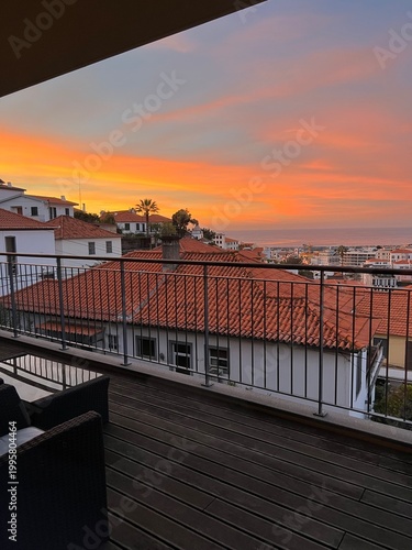 Vibrant orange sunset sky over Funchal rooftops, Madeira